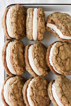 several cookies with white frosting are on a tray