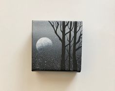 a black and white painting of trees with the moon in the sky behind it on a wall