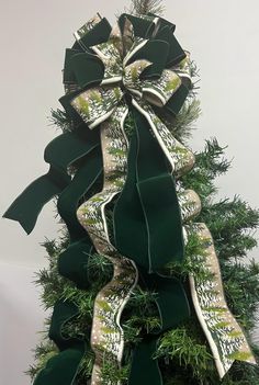 a christmas tree with green and white bows