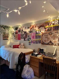 a dorm room is decorated with posters and lights