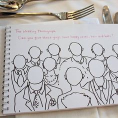 a notepad with an image of people on it next to silverware and forks