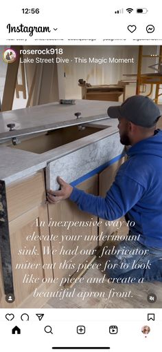 a man fixing a sink in a kitchen with an instagramtion message above it