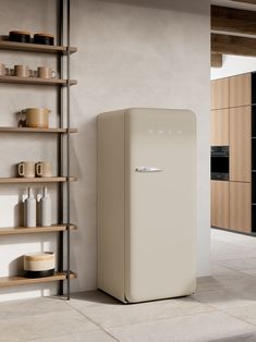 a white refrigerator freezer sitting next to a wooden shelf