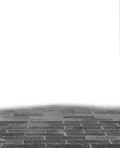 a black and white photo of a person on a skateboard in front of a brick wall