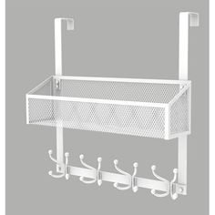 a white metal shelf with hooks on it