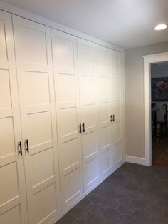 an empty room with white closet doors