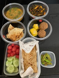 several plastic containers filled with different types of food