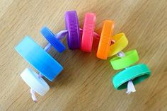 several different colored hair clips sitting on top of a wooden table next to each other