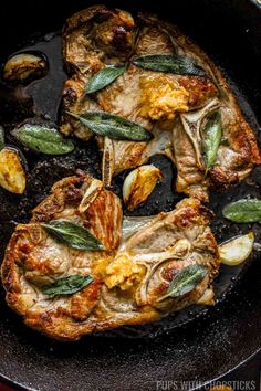 pork chops in a skillet with sage and potatoes