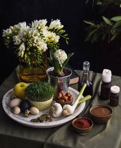 a table topped with lots of different types of food and flowers on top of it