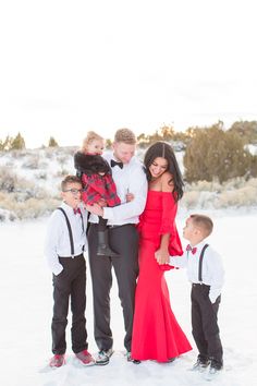 a family poses for a photo in the snow with their two sons and one sister