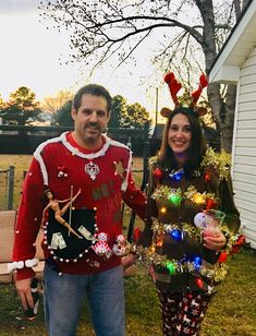 a man and woman dressed up in christmas sweaters standing next to each other outside