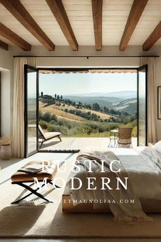 a bedroom with an open window overlooking the countryside