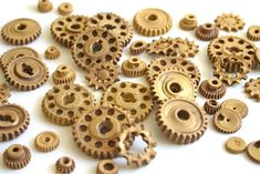 wooden gears are scattered on a white surface