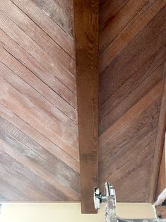 the underside of a wooden ceiling with metal brackets