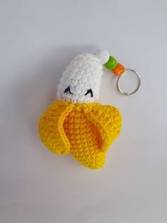 a crocheted keychain with a stuffed animal in the shape of a banana