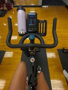 a person riding a stationary bike on a wooden floor