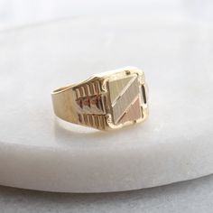 This stunning signet ring features a brushed gold, rectangle center plate with a white, rose and yellow gold finish, and a textured yellow and white gold patterning on the shoulders. This ring would make the perfect customizable gift for any special person in your life! Metals: solid 10k yellow,rose and white gold center signet (approx. 9.6 x 7.2 mm)  solid 10k yellow and white gold setting solid 10k yellow gold band 5 grams Please allow up to 5 business days for processing. Currently only shipping within Canada and the US. | c u r a t e d | Visit our website for curated and modern pieces  https://www.menkduke.com | f a c e b o o k | Follow us on Facebook for new item announcements and discounts  https://www.facebook.com/menkDUKE/ | i n s t a g r a m | Follow us on instagram to see what we Mens Gold Ring Vintage, Mens Wedding Rings Gold, Men Rings, Gold Chevron, Mens Gold Rings, Diamond Engagement Rings Vintage, White Gold Set, Gold Signet Ring, Customizable Gifts