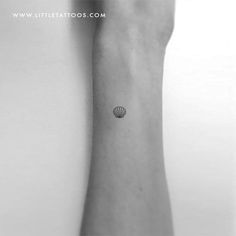 a black and white photo of a shell tattoo on the wrist by littlelitatoos com