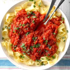 a white bowl filled with pasta and sauce