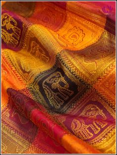 Epitome of luxury and grace, this Kanchipuram silk saree in a stunning color combination is just enough to steal any ocassion. Checkered patterned body in tones of red, yellow and dark green with gold zari woven elpehant and peacock motifs and zari woven border makes it a perfect showstopper for special occasion . Rich pallu adds grandeur. It comes with an unstitched plain blouse. Silk mark certified. Handloom saree. Handmade tassels. Edging done on the other side. Blouse - Unstitched. Please no Elegant Multicolor Zari Weaving Saree, Elegant Multicolor Saree With Zari Weaving, Elegant Multicolor Saree With Self Design, Red Tissue Silk Saree For Traditional Ceremonies, Red Handloom Tissue Silk Blouse Piece, Elegant Multicolor Blouse With Zari Weaving, Elegant Multicolor Blouse Piece With Zari Weaving, Elegant Multicolor Slub Silk Traditional Wear, Elegant Red Tussar Silk Blouse Piece