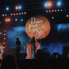 the band daisy jones on stage at an event