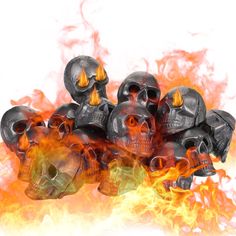 a pile of skulls sitting next to each other on top of a fire filled field