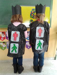 two children wearing costumes made to look like they are standing in front of a chalkboard