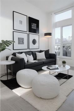 a black and white living room with pictures on the wall