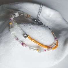 This handcrafted bracelet features a vibrant combination of orange, white, and purple beads, designed to create a cheerful and unique accessory. The playful colors bring a lively touch to any outfit, making it perfect for both casual and festive occasions. Ideal for gifting or treating yourself to a special, one-of-a-kind piece. Adjustable length High-quality glass beads Handmade with love and care ✴︎Each design is created in extremely limited quantities, with only 1 or 2 pieces made per style. This exclusivity ensures that you are purchasing a truly unique piece of jewelry that stands out. Adjustable Orange Beaded Chain Bracelets, Trendy White Bracelets With Beaded Chain, Trendy White Beads For Friendship, Trendy White Beaded Chain Bracelets, White Round Beads Friendship Bracelets For Jewelry Making, Orange Bracelets With Colorful Beads For Jewelry Making, White Beaded Chain Friendship Bracelets As Gifts, Orange Tiny Beads Friendship Bracelets As Gift, White Beaded Chain Friendship Bracelet As Gift