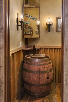 a bathroom with a wooden barrel sink and mirror