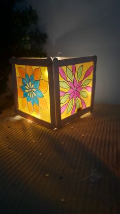 a lit up box sitting on top of a wooden table