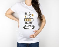 a pregnant woman wearing a white t - shirt with the words baby loading please wait