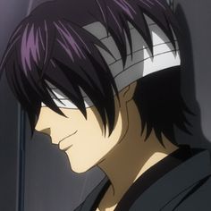 a man with purple hair wearing headphones