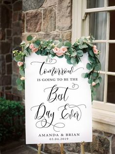 a white sign with greenery and flowers on it that says, compresse is going to be the best day ever