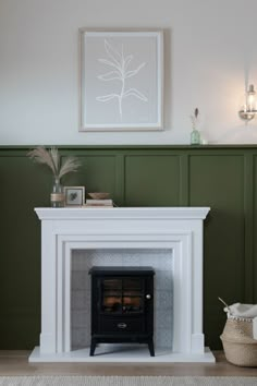 a fireplace in a living room with green walls