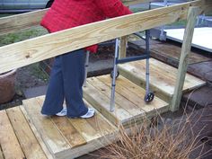 a woman standing on top of a wooden ramp