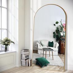 a living room with a large mirror in the corner