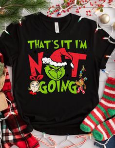 GRINCH CHRISTMAS SHIRT - That's It, I'm Not Going T-Shirt Add a touch of humor to your holiday wardrobe with our Grinch Christmas Shirt. Perfect for those who prefer to keep their holiday plans low-key, this shirt combines classic comfort with a cheeky twist. Product Features: Material: Made from 100% cotton for a soft, breathable feel. Variants include Sport Grey (90% cotton, 10% polyester), Ash Grey (99% cotton, 1% polyester), and Heather colors (50% cotton, 50% polyester). Fabric Weight: 5.0-5.3 oz/yd² (170-180 g/m²) for a substantial, comfortable wear. Fit: Classic unisex fit that offers a structured look, perfect for layering or wearing solo. Design: Features a tubular fabric construction and open-end yarn for durability and a neat appearance. Details: Includes a taped neck and should Grinch Holiday Shirts, Grinch Christmas Shirt, Grinch Shirts, Christmas Tee Shirts, Holiday Humor, Holiday Wardrobe, Grinch Christmas, Christmas Tees, Ash Grey