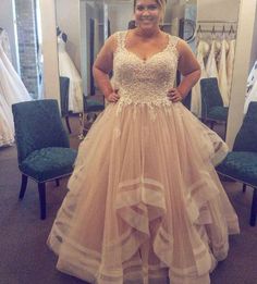 a woman standing in front of a mirror wearing a dress