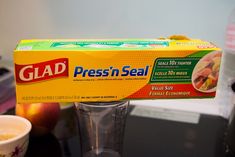 a box of glaad sits on top of a blender next to a cup