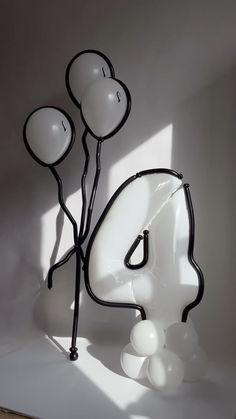 an artistic sculpture made out of balloons in the shape of a number four