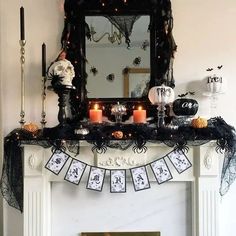 a mantle decorated with halloween decorations and candles