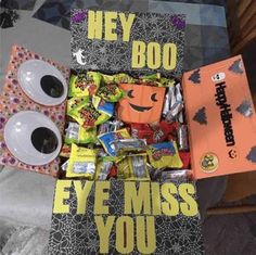 a halloween treat box with candy, candies and other treats in it that says hey boo eye miss you