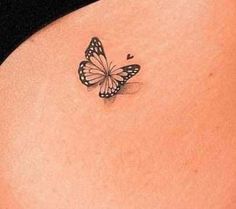 a woman's stomach with a small butterfly tattoo on the side of her belly