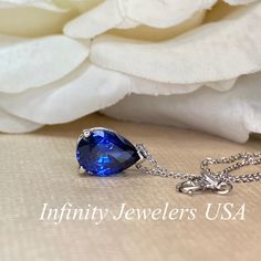 "The pendant pictured is a lab created blue sapphire #6864 -Approximate total carat weight: approx. 2.00ctw diamond equivalent -Center Stone Size: 10x7mm - approx. 2.00ct diamond equivalent -Center Stone Shape: pear -Gem Type: lab created sapphire -Stone Clarity: VS2 -Stone Color: Blue -Moh's Scale: 9 hardness -Metal Type and Purity: 14k yellow gold -Setting: 3 prong basket design -Chain: delicate 14k gold chain / heavier option with lobster claw available (use dropdown to select) -Country of Ma Teardrop Sapphire Necklace In Fine Jewelry Style, Fine Jewelry Sapphire Teardrop Necklace, Fine Jewelry Sapphire Drop Necklace, Fine Jewelry Sapphire Teardrop, Fine Jewelry Pear-shaped Sapphire, Formal Tanzanite Teardrop Jewelry, Formal Sapphire Pear-shaped Necklaces, Blue Teardrop Pendant Jewelry For Formal Occasions, Blue Teardrop Pendant For Formal Occasions