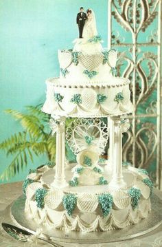 a wedding cake with blue and white decorations