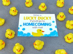 there are many rubber ducks in front of a sign that says, i'd be a lucky ducky if you go to home coming with me