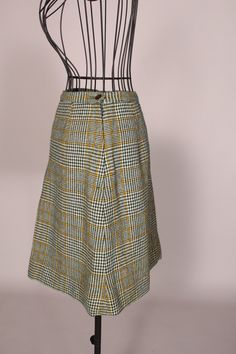 "60s Skirt // Mini Skirt Wonderful vintage 60's green and yellow plaid mini skirt with cute front pleat, by Scaasi for Lortogs! So cute, and in great condition! Waist:24\" Hips:38\" Length:19\" Label: Scaasi for Lortogs 2016-12" Retro Green Lined Skort, Retro Green Mini Skirt, Retro Plaid Mini Skirt Bottoms, Retro Plaid Mini Skirt, Vintage Pleated Mini Skort, Retro Plaid Knee-length Skirt, Vintage Plaid Skirt For Work, Retro Knee-length Plaid Skirt, Retro Green Skirt For Fall