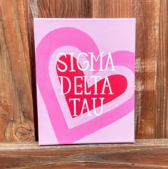 a pink heart with the words sigma delia tal on it